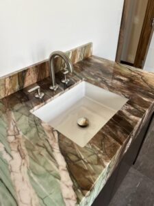 a bathroom sink with marble counter top