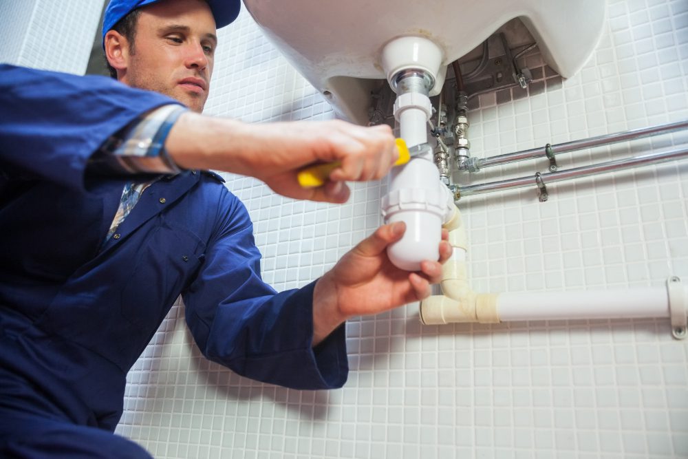 frowning-plumber-repairing-sink