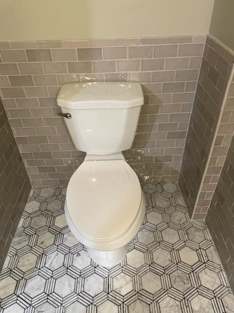 professional-plumber-uniform-is-repairing-toilet-bowl-domestic-bathroom-with-help-tools
